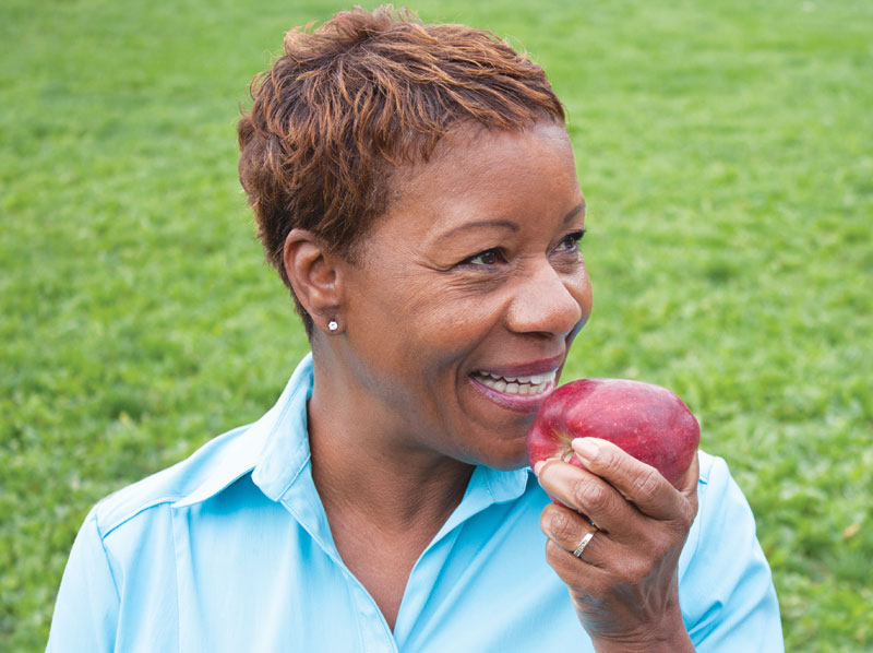 Lady enjoying an apple.