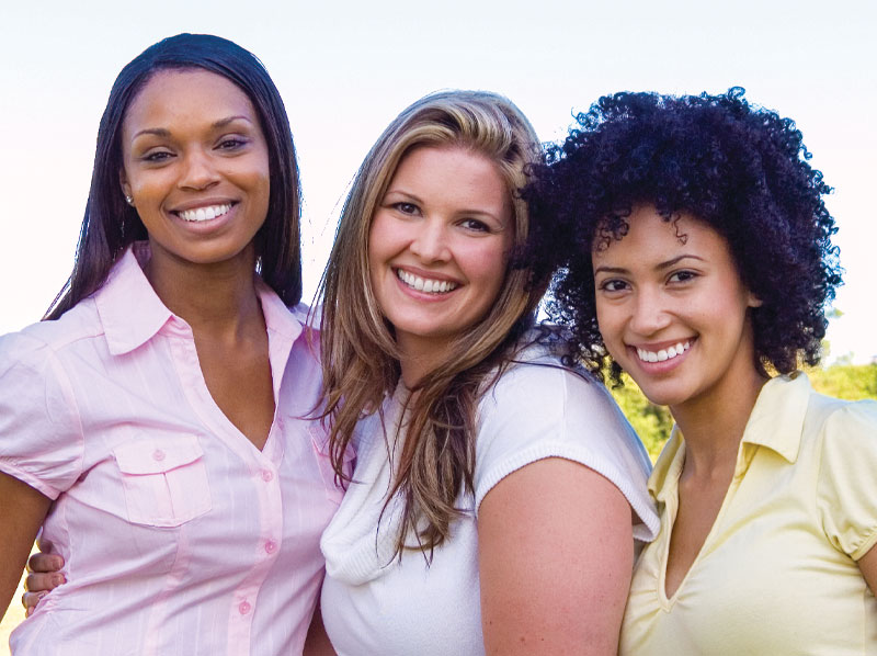 Three lady friends smiling.